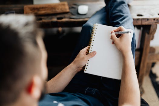 man writing in a health journal