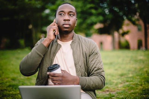 Image of a man sitting alone in a park, looking pensive